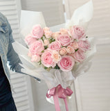 Bouquet of pink roses with a pink ribbon.