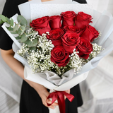 Bouquet of red roses with greenery 